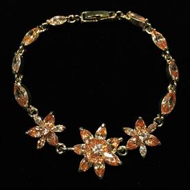-,TOPAZ CZ FLOWER BRACELET IN GOLD TONE METAL. 7.25" LONG.                                                                                  