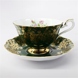 ,UN-NAMED 1970'S-1980'S HUNTER GREEN & GOLD FLORAL CHINTZ WITH LILAC ROSES AVON SHAPED TEACUP & SAUCER. 4" DIA., 5" WIDE, 2.5" TALL.        